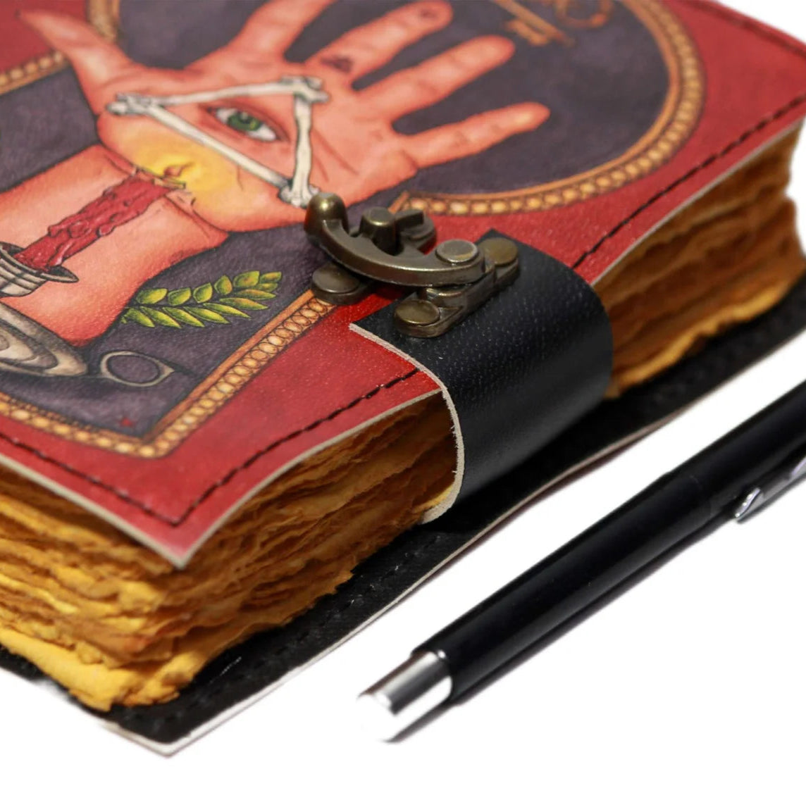 Decorative notebook with tarot card design and a pen on a white background