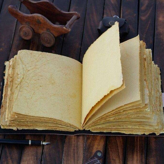 Open book with yellowed pages on a wooden surface