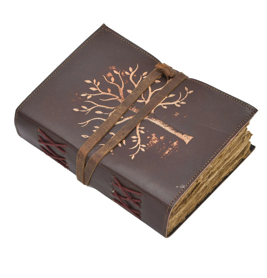 Brown leather journal with tree design and strap closure on a white background