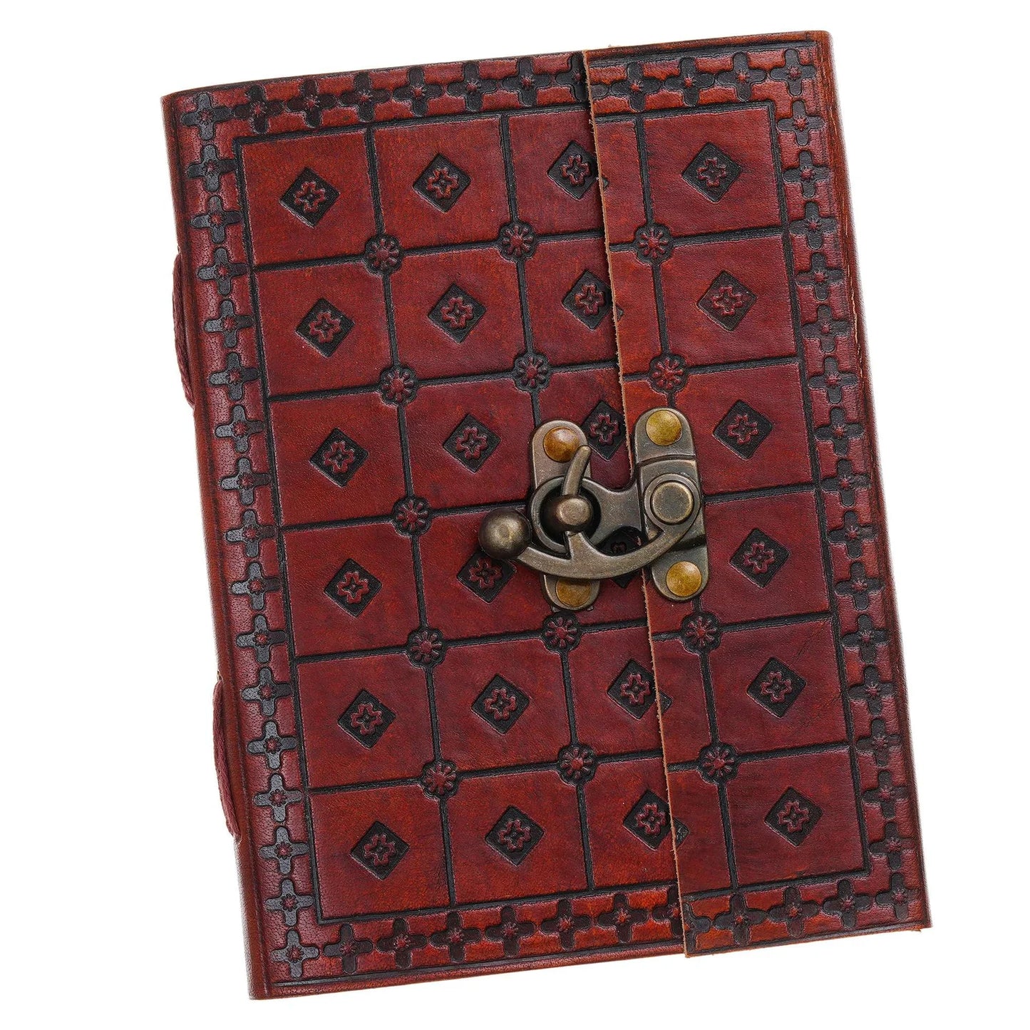 Open notebook on a textured surface with a pen, small plant, and decorative items.