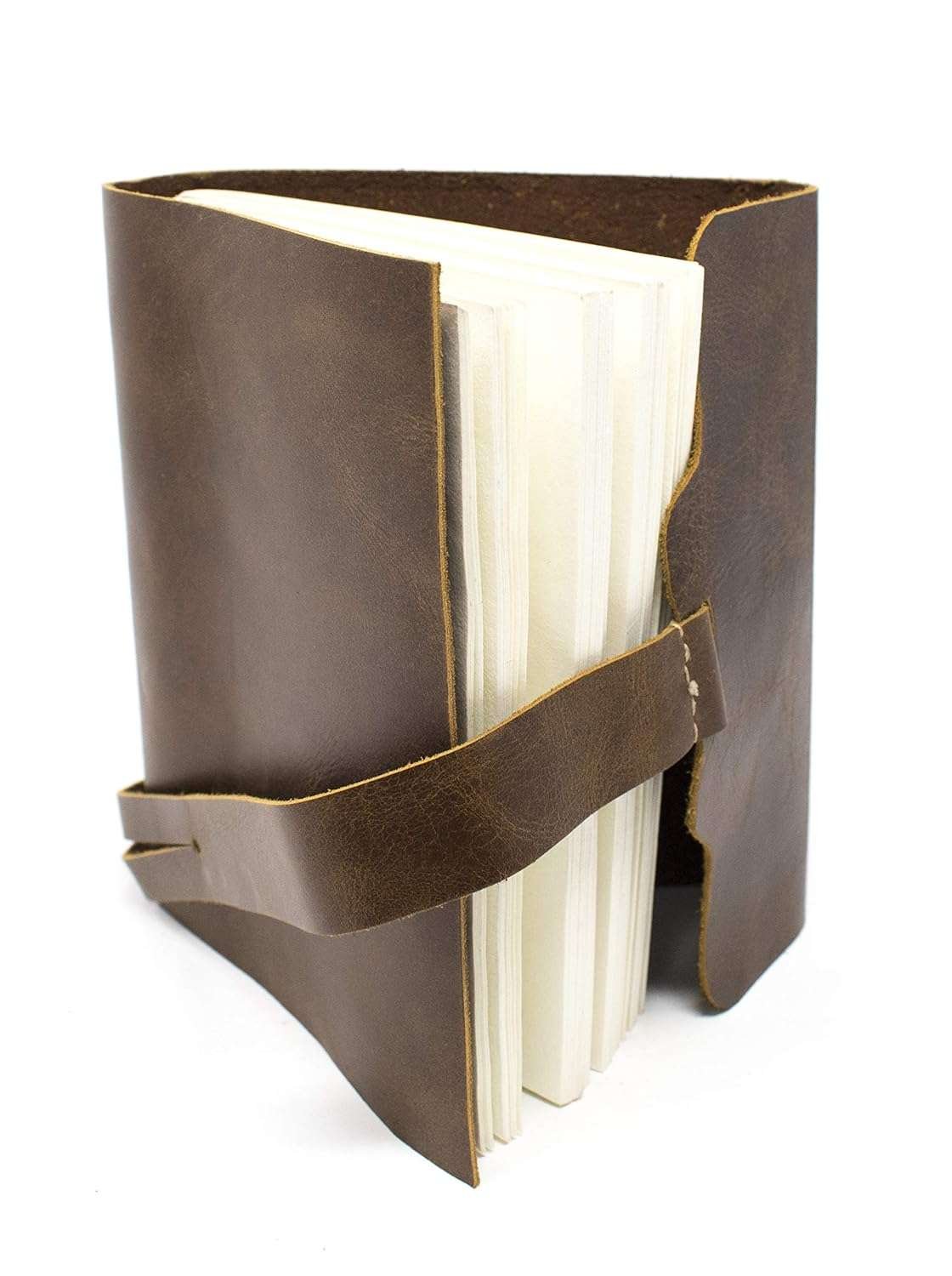 Brown leather-bound book with a strap on a white background