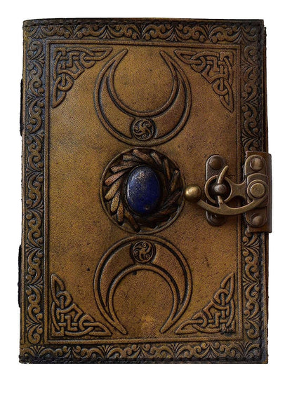 Decorative leather-bound book with Celtic knot patterns and a blue stone on a white background