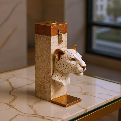 Decorative object with a leopard head on a marble surface