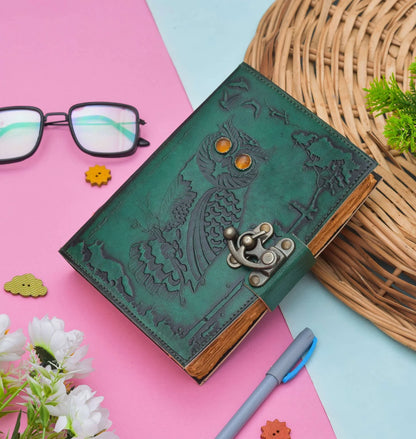 Green leather notebook with owl design on a colorful background