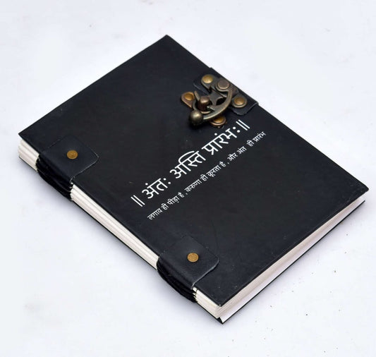 Black leather notebook with brass fasteners on a white background